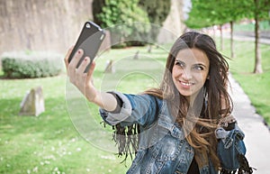 Young brunette woman taking a selfie