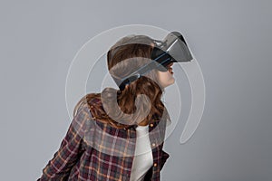 Young brunette woman testing virtual reality helmet