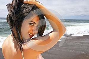 Young brunette woman vacationing on the beach