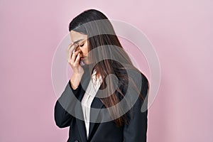 Young brunette woman wearing business style over pink background tired rubbing nose and eyes feeling fatigue and headache