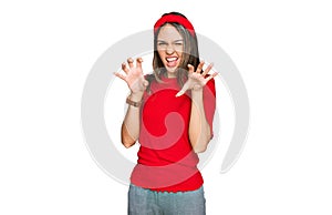 Young brunette woman wearing casual clothes smiling funny doing claw gesture as cat, aggressive and sexy expression