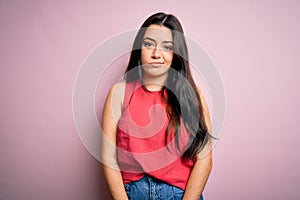 Young brunette woman wearing casual summer shirt over pink isolated background looking sleepy and tired, exhausted for fatigue and