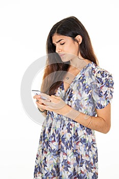 Young brunette woman on white background texting sending text message with smartphone mobile phone