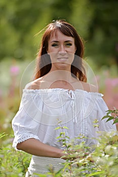 Young brunette woman in white dress