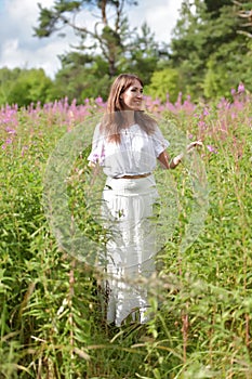 Young brunette woman in white dress