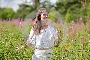 Young brunette woman in white dress