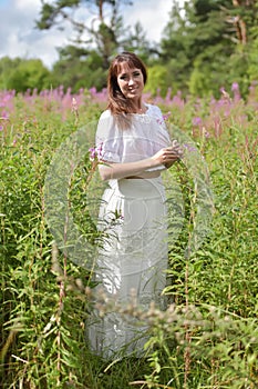 Young brunette woman in white dress