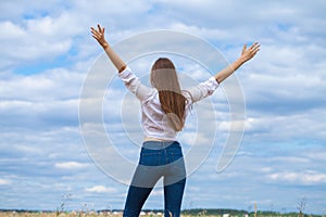 Young brunette woman in white shirt and blue jeans