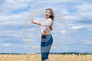 Young brunette woman in white shirt and blue jeans