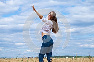 Young brunette woman in white shirt and blue jeans