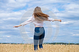 Young brunette woman in white shirt and blue jeans