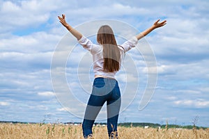 Young brunette woman in white shirt and blue jeans