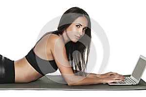 Young brunette woman working on her laptop