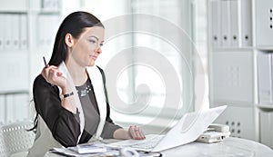 Young brunette woman working at office