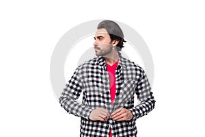 young brutal bearded brunette man in a shirt on a white background with copy space