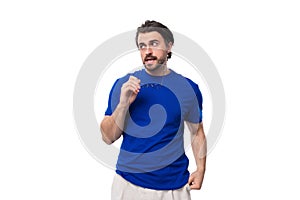 young brutal stylish brunette man with a beard dressed in a blue t-shirt with a mockup on a white background