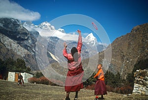 Young Buddhist monks playing frisbee