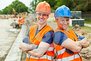 Young builders in helmets