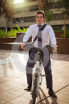 Young buinessman riding to work in the city