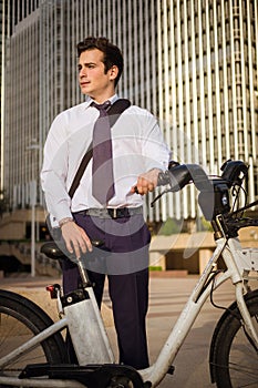 Young buinessman riding to work in the city