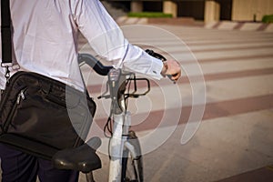 Young buinessman riding to work in the city