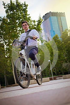 Young buinessman riding to work in the city