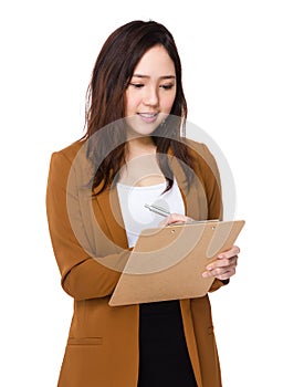 Young Buisnesswoman write on clipboard