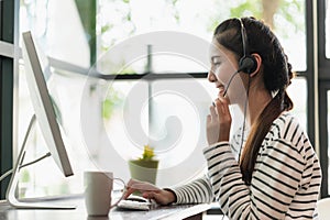 Young business asian woman working call centre customer service agents. Business female support operator with computer and headset