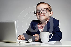 Young business boy. smiling child in glasses. little boss in office