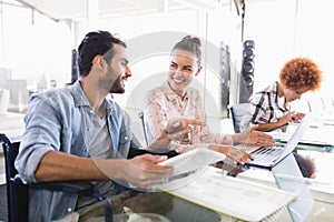 Young business colleagues discussing at creative office