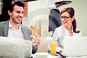 Young Business Couple In A Cafe