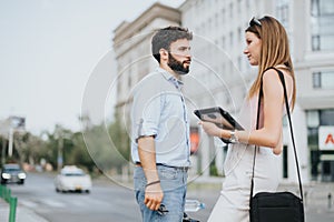 Young business couple discussing new business ideas and expansion plans in the urban city center.