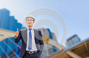 Young business engineering man standing and showing thumb up