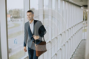 Young business executive with briefcase going up the stairs