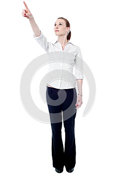 Young business executive pointing upwards