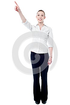 Young business executive pointing upwards