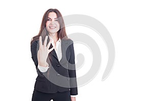 Young business female showing number four with fingers