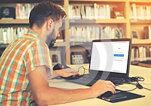 Young business hipster man working on his laptop