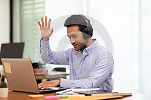 Young business indian man meeting with business team via video conference call at Home