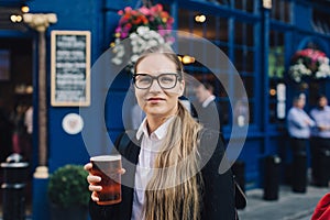 Young business lady with beer.