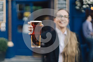 Young business lady with beer.