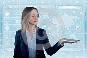 Young business lady in futuristic office with HUD. Global corporate concept