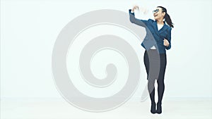Young business lady standing on a white background. He holds money in his arms and smiles sincerely. During this time
