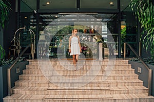 Young business lady walking down the stairs