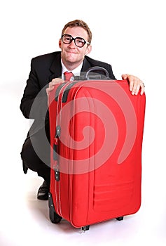 Young business man behind red luggage