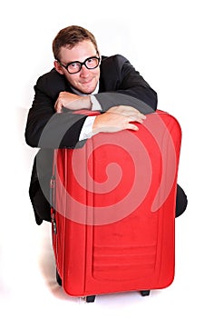 Young business man behind red luggage