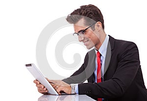 Young business man browsing on his tablet pad