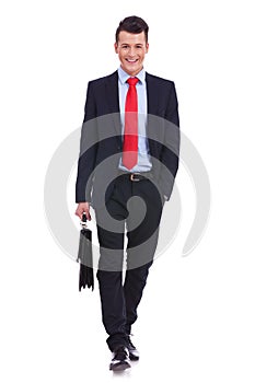 Young business man carrying a suitcase