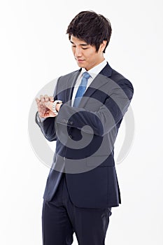Young business man consulting his watch