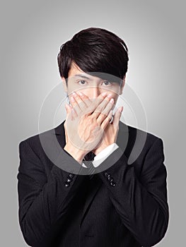 Young business man covering his mouth